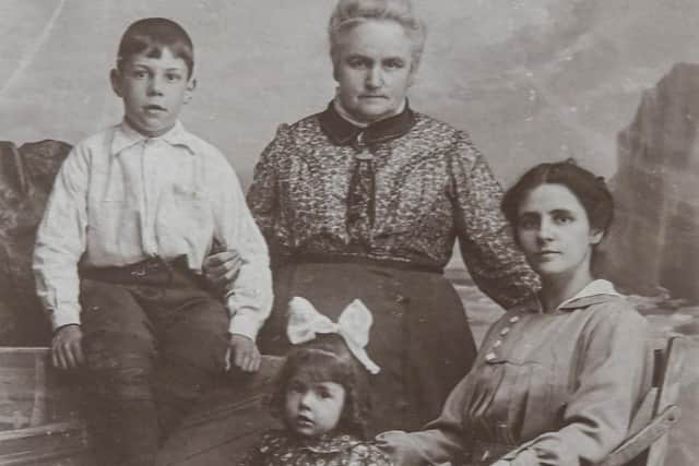 Marjorie as a little girl, pictured with her older brother Fred, their mother Gertrude and Grandma Norcliffe.