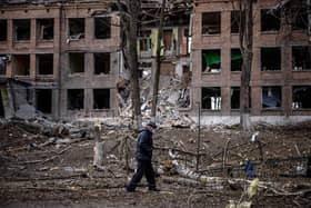 A man walks in front of a destroyed building after a Russian missile attack in the town of Vasylkiv, near Kyiv, on February 27, 2022. Photo by DIMITAR DILKOFF/AFP via Getty Images