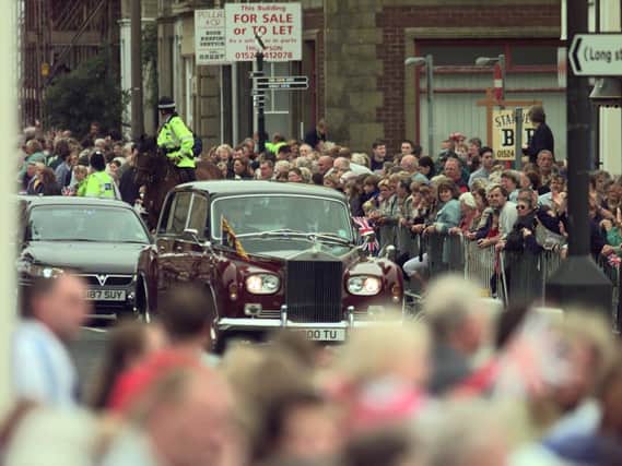 Crowds in Morecambe line the promenade to welcome The Queen and Prince Philip who were unveiling the Eric Morecambe statue in 1999.