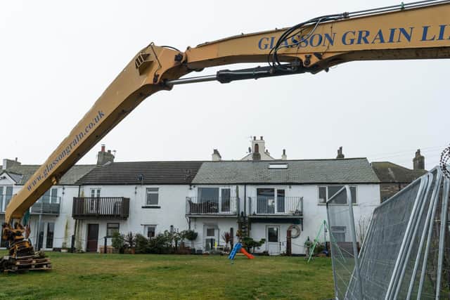 A crane and fencing left opposite houses in Glasson Dock. Photo by Kelvin Stuttard
