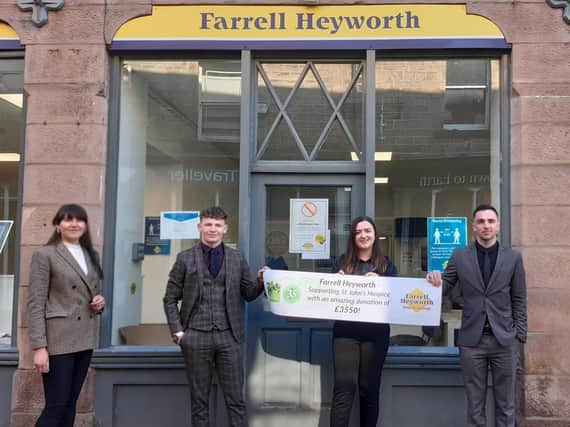 The staff of Farrell Heyworth Lettings Office in Lancaster with their thank you banner from St John’s Hospice.