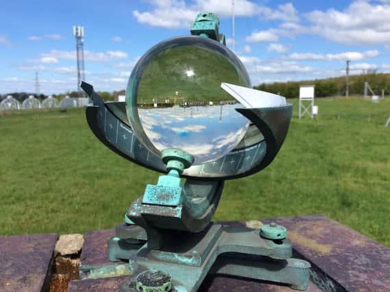 A Campbell Stokes sunshine recorder at Hazelrigg weather station. It uses a magnifying glass which burns a card when it is sunny to leave a recording.