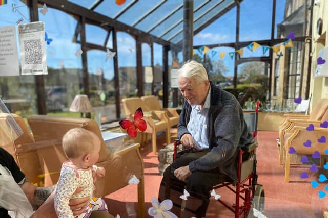 Tom Hanley meeting his new great-granddaughter April Hanley through a perspex screen recently.