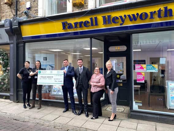 The team at Farrell Heyworth hand over the cheque to Rachel O'Neil (second left).