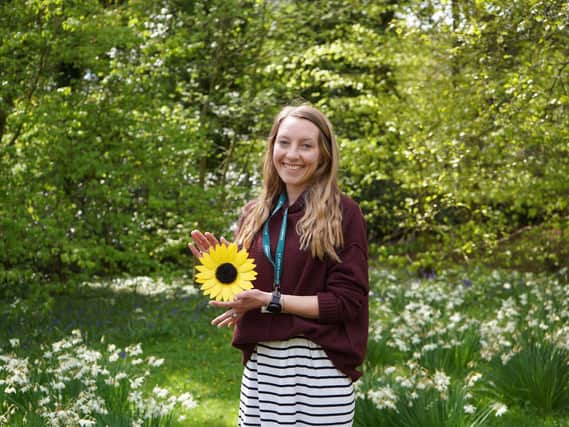 Natalie Santamera with a sample sunflower.
