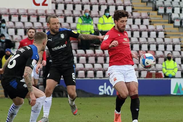 Jay Spearing (challenging Cole Stockton) has had his say on Morecambe's play-off semi-final with Tranmere Rovers