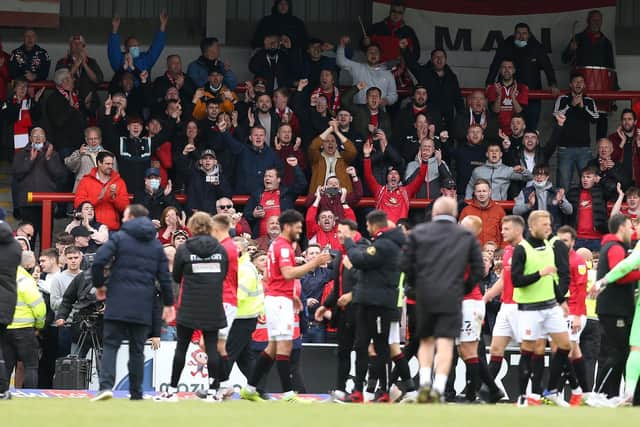 Morecambe's players and supporters celebrate reaching Wembley