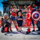 Lancaster Supehero event in Market Square. Savie Ates and children Rodi and Azra pose with the Super-Team. Picture by Martin Bostock.