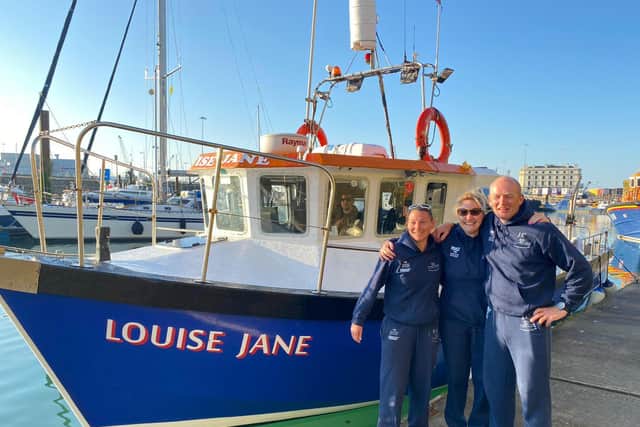 Rachael Edmonds with co-swimmers Jim Cleaver and Alex Loydon and the boat which took them on their Channel swim.