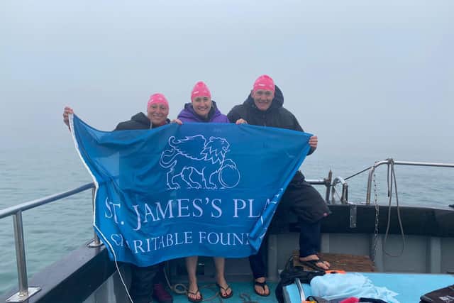 Rachael Edmonds with co-swimmers Jim Cleaver and Alex Loydon on the boat in thick fog.