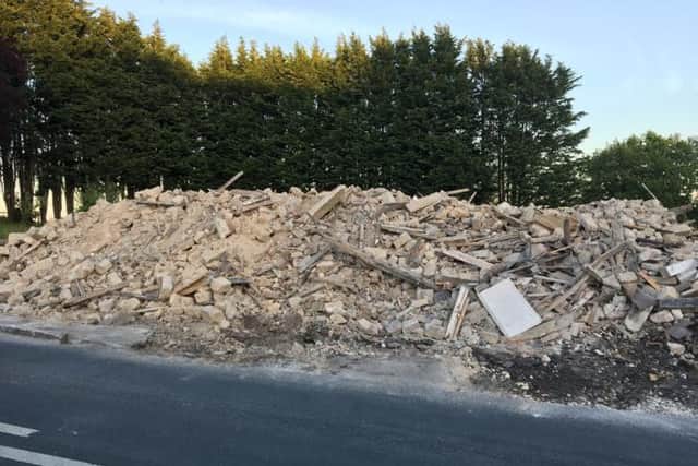 The rubble on the roadside site where the Punch Bowl Inn stood until earlier this week