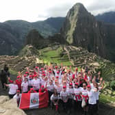 The Peru trekkers arrive at Machu Picchu in 2018. Debbie is front row, fourth from right.