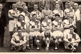 Photograph of Caton United 1948-1949 at Jowett’s Field, Caton, with a clean sweep of  trophies won in that season, Division1 title, Parkinson Cup & Senior Challenge Cup.Back row from left: Dick Woolcock, George Wilson, Stanley Walker, Bill Dainty, George Robinson. Middle row from left: Tom Eglin, Bill Hodgson, Jimmy Till, Jimmy Clarkson, Bert Cartmel, Albert Robinson, R. Bowker, Ritson Stockdale, Sid Southward 
Front row from left: Fred Robinson, Joe Easterby, Jock Kerr (captain), Ted Fairclough, Cyril Gardner. Sat on the ground from left: Jimmy Mason, Frank Woodhouse.