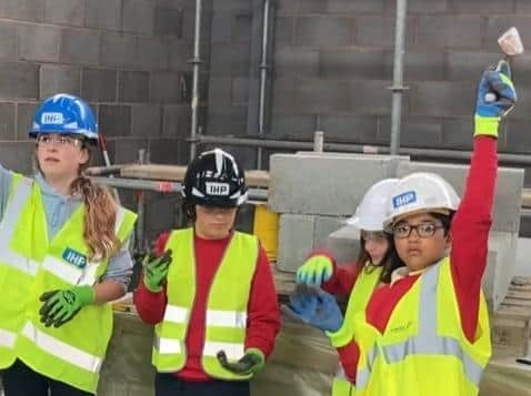 Bowerham Primary School pupils laying the final bricks of the Energy Centre.