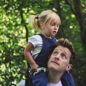 Dad carrying his daughter on his shoulders through an RSPB nature reserve. Picture copyright RSPB Leighton Moss.