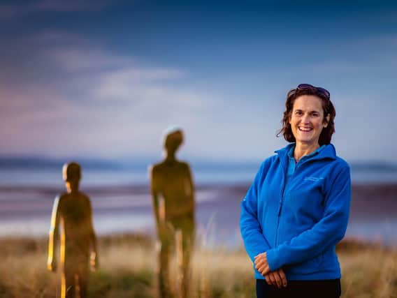 Susannah pictured in Heysham, with Rob Mulholland's artwork Settlement. Photo credit: Robin Zahler