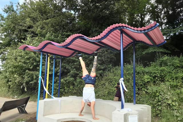 Olympic gymnast Brinn Bevan performs for the crowd a the opening of the finished seating area.