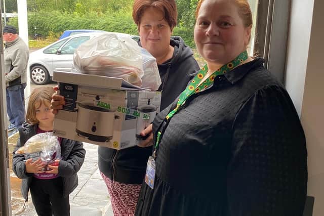 Clare Southworth hands over one of the slow cookers to a resident.