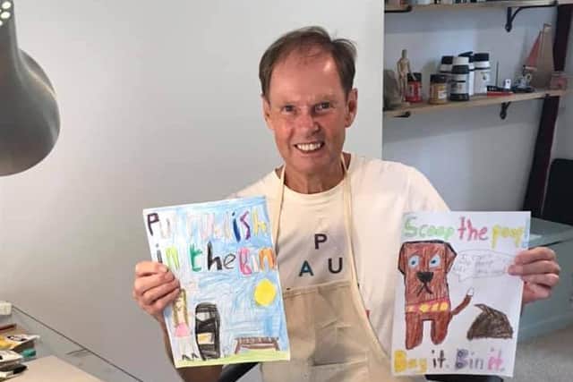 Local artist Chas Jacobs with the two winning entries in the Halton Neighbourhood Watch Group litter poster competition.