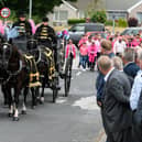 Mourners line the streets as the horse-drawn carriage makes its way on Frank's final journey.