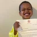 Proud Noah with his letter from the Queen.