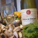 A glass of Côtes-du-Rhône Blanc, Guigal, as the creamed mushrooms and spinach is prepared