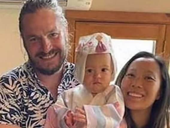 Jonathan Gerrish, his partner Ellen Chung and their one-year-old daughter.