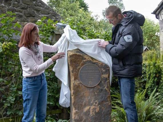 Norah Hoyles' children Sharon and Stephen unveil the memorial plaque in Norah's garden  photo: Michael Coleran