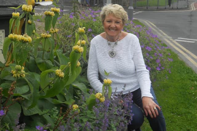 Norah pictured by a Garstang in Bloom flowerbed