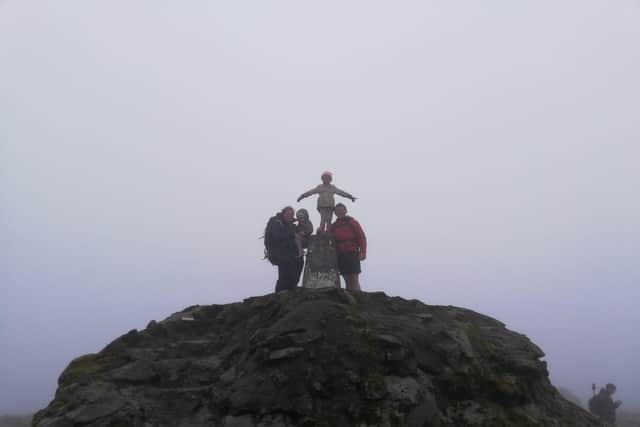 Megan Longdon-Wright with dad Frank, mum Gemma and sister Robyn, three, at the top of Ben Nevis.