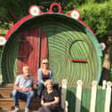 Sue Mantle (front) with her niece Lisa and her husband Gerry with the house in The Hobbit, The Dukes promenade play in Williamson Park, Lancaster in 2016. The picture was taken by Sue's great nephew Alfie.