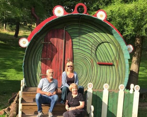Sue Mantle (front) with her niece Lisa and her husband Gerry with the house in The Hobbit, The Dukes promenade play in Williamson Park, Lancaster in 2016. The picture was taken by Sue's great nephew Alfie.