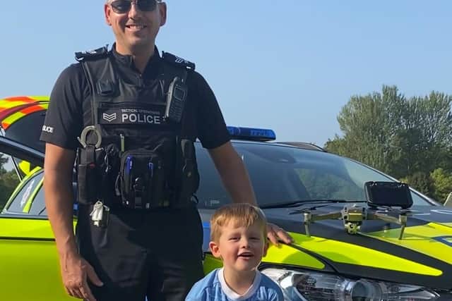Sgt Andy Barlow with drone competition winner Joshua Heaney, aged three.