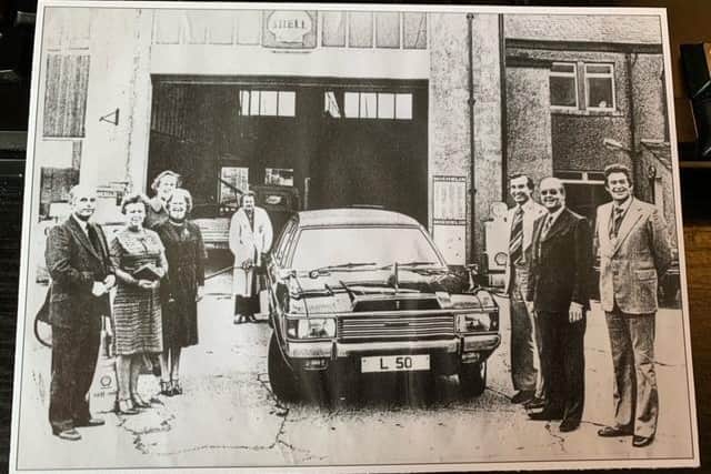 The new garage built in the early 1960s. The Lamb families are celebrating the first fifty years. Left hand group: Bob, Marjorie and Mary Lamb. Behind Mary, Mr Baldwin, Shell rep for the area. In the white coat was Clive Lamb. Right hand group: centre Ken Lamb, either side of Ken, men from Shell petrol.