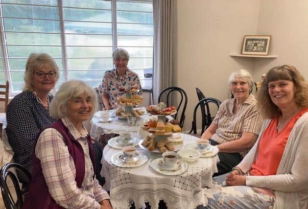 Members enjoy the afternoon tea as part of the birthday celebrations