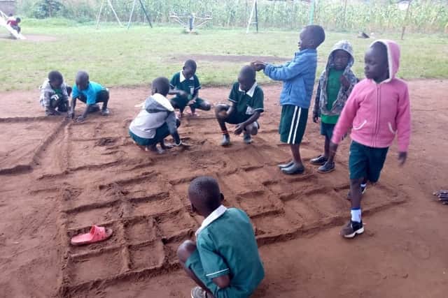 Excited children planning the new classrooms block.