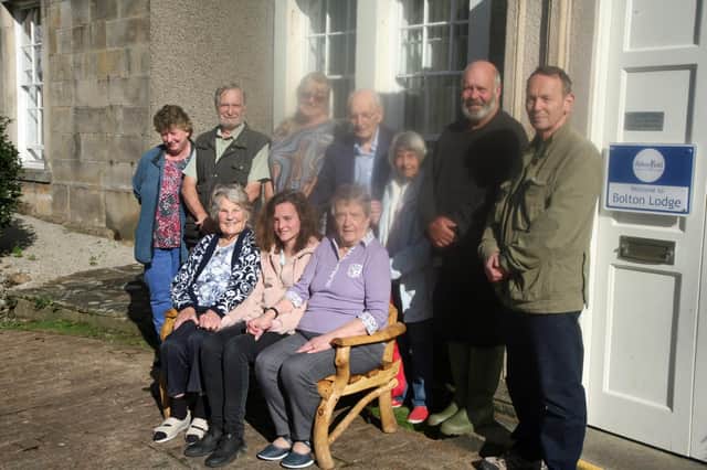 Caretaker Kate and Abbeyfield residents with Thwaite Brow Woods Conservation Project members with the seat at Bolton Lodge.