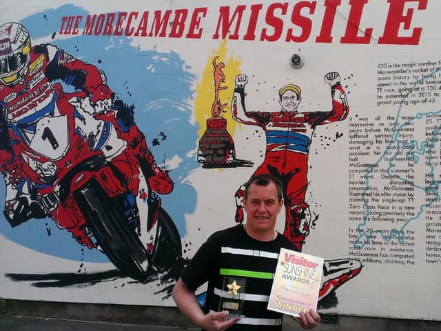 John McGuinness with the Sunshine Ambassador Award and the new mural in Morecambe paying tribute to his motorcycling achievements.