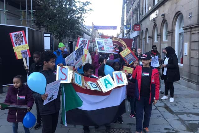 Children with a Sudanese banner at a protest against the military coup in Sudan in Lancaster on Saturday.