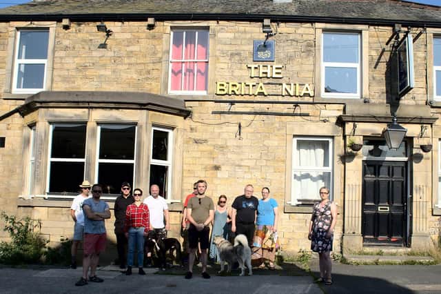 Couns Jack Lenox and Lizzi Collinge with residents outside The Britannia in Lancaster.