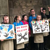 Pupils of Loyne Specialist School with placards they created during a Facing The Past art workshop.
