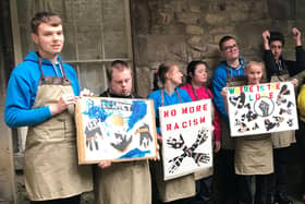 Pupils of Loyne Specialist School with placards they created during a Facing The Past art workshop.