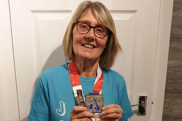 Lorraine shows off her medal for completing the walk.