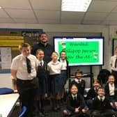 Pendle pupils campaigning for the return of a lollipop crossing a patrol to the busy A6  at Forton, near Garstang are pictured with headteacher Lorna Boase and form teacher Patrick Haley