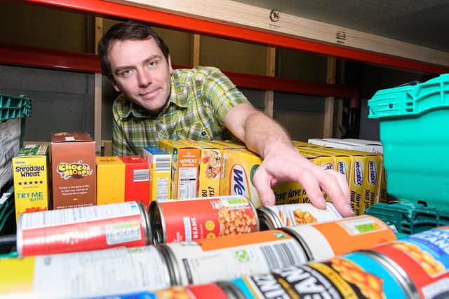 Manager of The Olive Branch Food Bank, Leslie Mann, collects a tin for a food parcel. Photo: Kelvin Stuttard