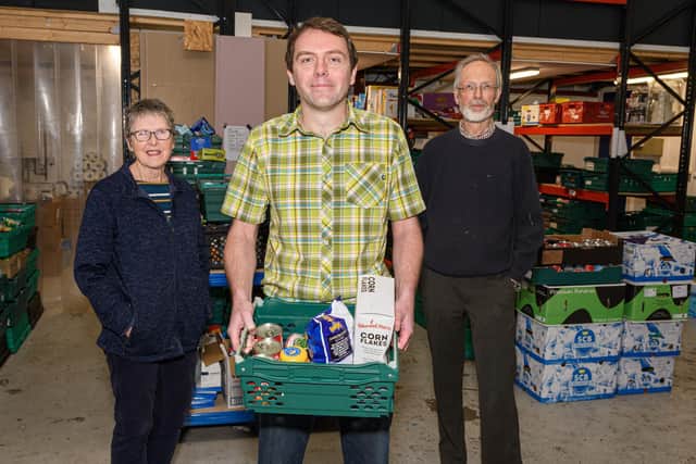 From left: Linda Currin, Leslie Mann and Edmund Dustan inside The Olive Branch Food Bank, which is appealing for more help over the winter months. Photo: Kelvin Stuttard