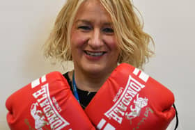 Pictured is Christine Metcalfe of Bay Hospitals Charity with the gloves signed by world heavyweight champ Tyson Fury
