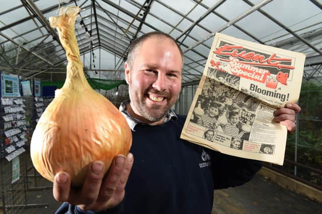 Andrew Redmayne, fifth generation in the business, pictured with one of the Mammoth onions and a cutting featuring him when he was a youngster at the nursery. Photo: Neil Cross