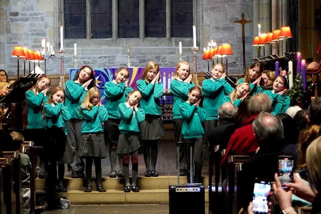 Members of St Wilfrid's school choir sing at the Carols by Candlelight.