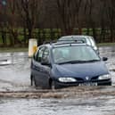 Cars negotiate the flood waters on Eastway, Fulwood, Preston